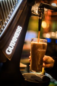 A Head for Profits teaches how to pour a Guinness the right way. Beer being poured into Guinness glass.
