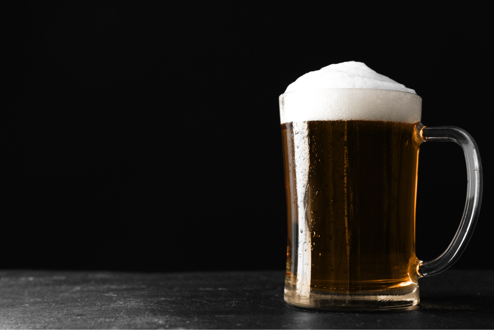 A pint of sudsy beer on draft